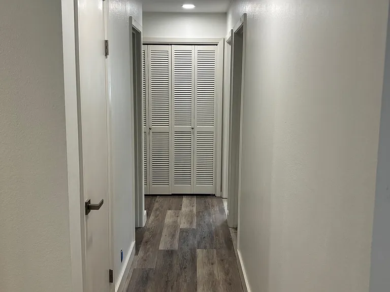 hall leading to 3 bedrooms and 2 baths