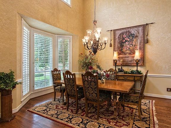 Expansive open formal dining room with soaring and impressive ceilings.