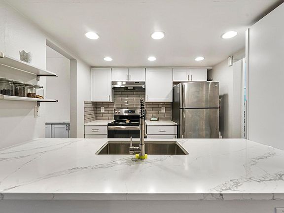Open Concept Kitchen w Stainless Still Appliances