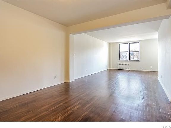 Welcome to your new two-bedroom co-op featuring a 32 x 12 living room with gleaming hardwood floors