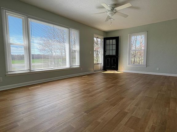 The large, light-filled living room with windows that showcase the countryside.