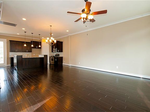  Perfect for sectionals and large dining room furniture. Dark hardwood flooring throughout family living, dining and kitchen.