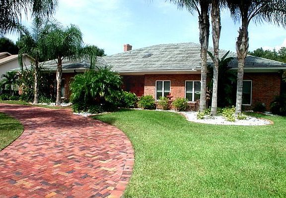Red brick circular drive provide plenty of parking and adds to curb appeal.