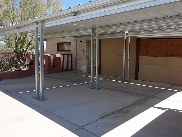 Parking behind the house - 2 covered car ports. There's also a circular driveway in the front of the house.