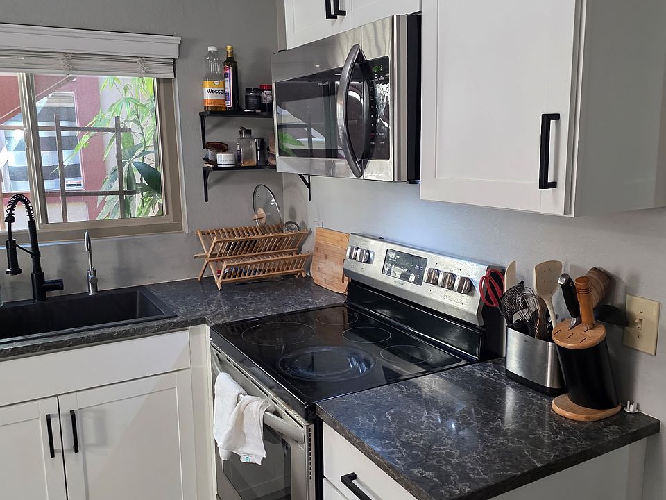 Kitchen. Brand new appliances installed in 2021. Quartz counter tops and porcelain tile.