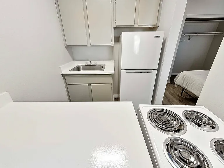 Explore this charming kitchenette with seamless bedroom access, perfect for modern living.