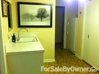 Landry room has 1/2 bath, sink and freezer