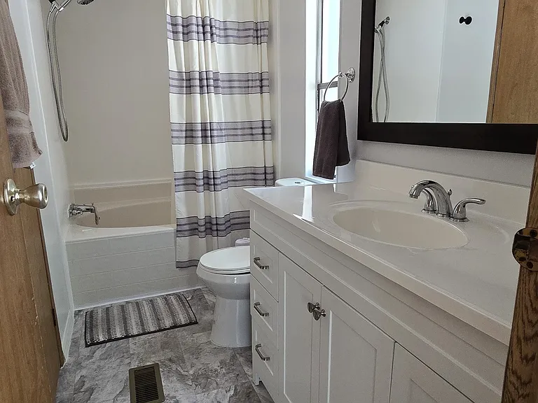 Primary Bathroom
"Attached bathroom with full tub and stylish updated fixtures."