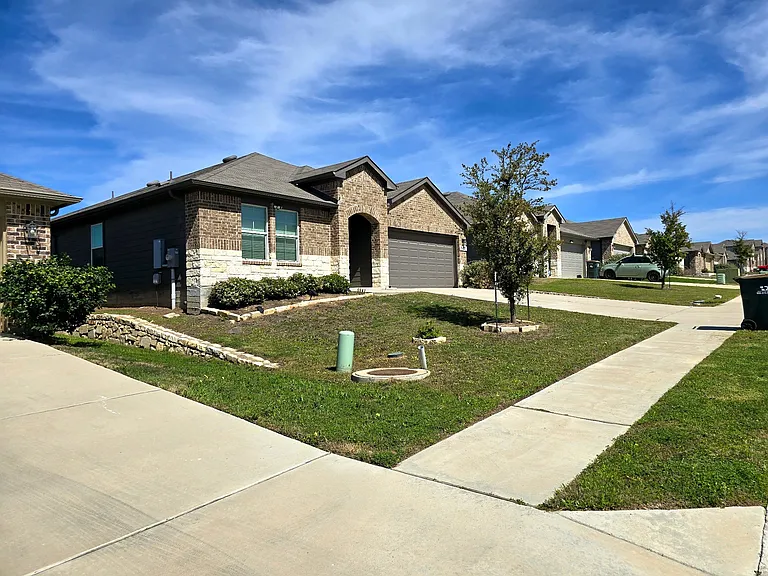 Well-maintained exterior with private driveway and clean landscaping.