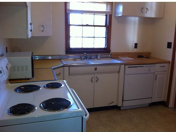 Kitchen with refrigerator, stove, microwave, dishwasher, and plenty of very clean cabinets,