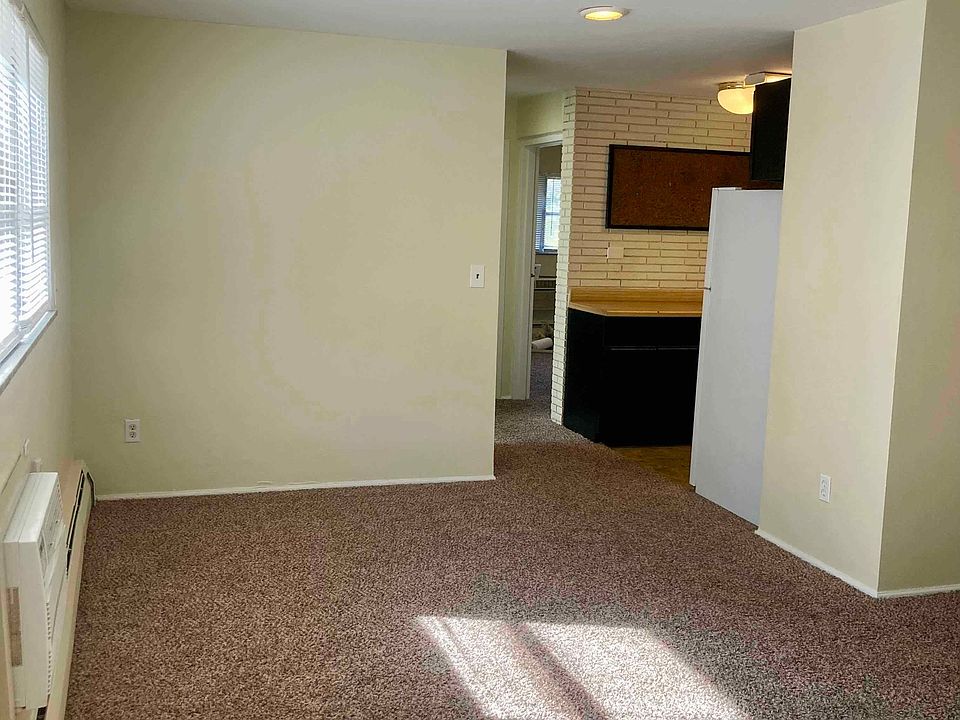 Living room area looking towards kitchen and hallway