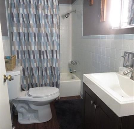 Cute updated bathroom with new sink, flooring, and paint.