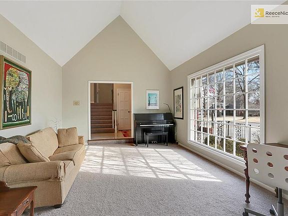 Newly retiled entryway leads to formal living room with soaring ceilings and tons of light. This is the view from the formal dining room.