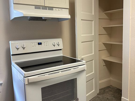 Pantry. Glass-top range with hood and cabinet.