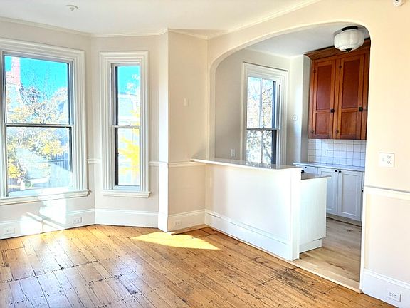 Living Room archway into kitchen with bar for seating