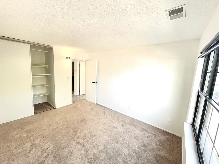 Another view of the second bedroom towards the closet and hall