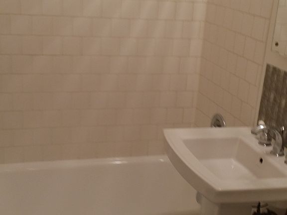 Full bath nicely tiled