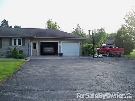 North side of front view : Attached 2 car garage! Also, stone parking beside of garage.