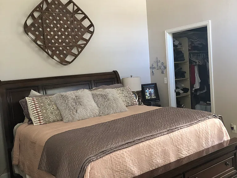 Large primary bedroom with vaulted ceilings.