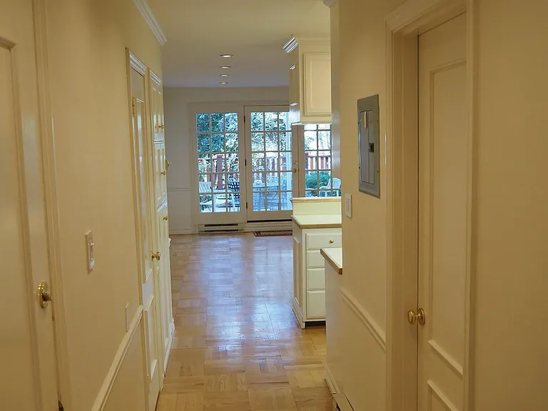Hallway and living room. Bathroom door to right. Entry door to left. Private patio beyond French doors.
Parquet hardwood floors. Recessed lighting.