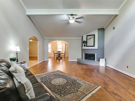Large living room with new floors and a cozy gas fireplace.