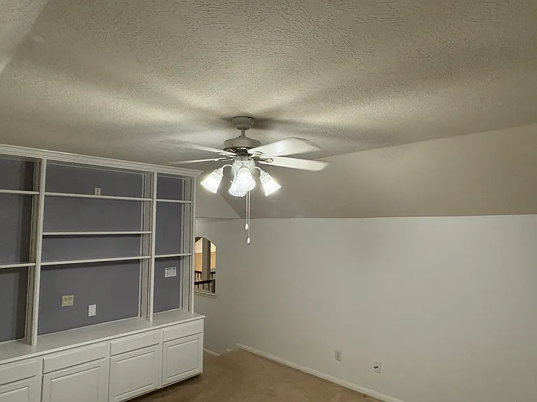 Game room entry (empty shelves)