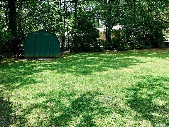 Fenced yard with shop.