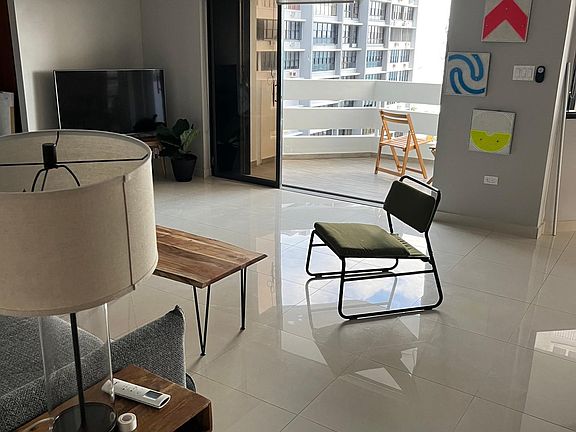Living room with sliding doors open to balcony