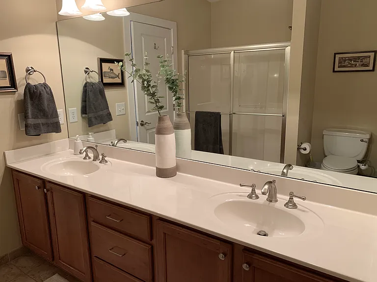 Main bedroom bathroom with 2 sinks and a shower
