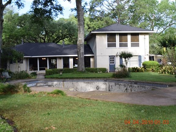 This home sits well back from the street. There are extensive garden areas, shaded areas for outside enjoyment, and a long driveway, useful for on site parking for visitors.