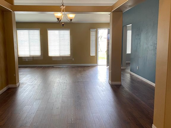 front entrance into living room & open dining area looking from family room/kitchen