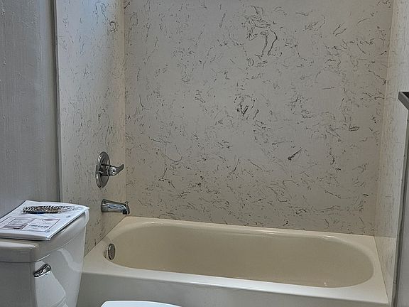 Entirely new bathroom complete with led lighting throughout and ceiling fan. Marble vanity, Quartz surround for bathtub, rainfall shower head, and water saving elongated toilet.