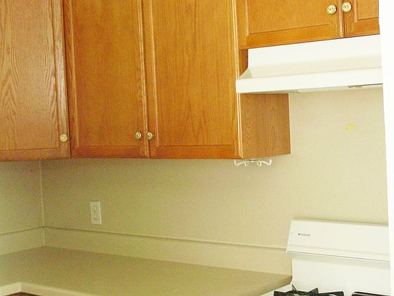 More of the kitchen cabinets, gas stove &  eat in breakfast area.