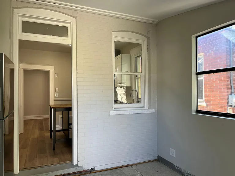 Large back room with fantastic natural light opens to backyard. Great flex space for a mudroom/entry, breakfast nook, work space, etc.