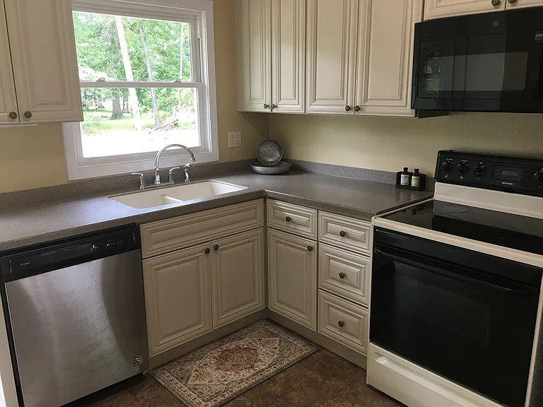 Kitchen includes refrigerator, stove, dishwasher and over the range microwave.
