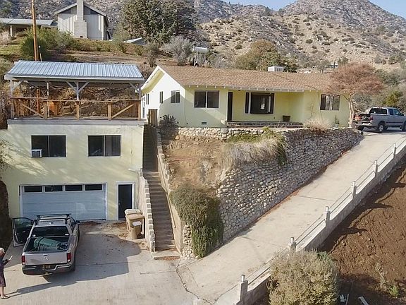 Garage, studio, covered deck on left, main house on right