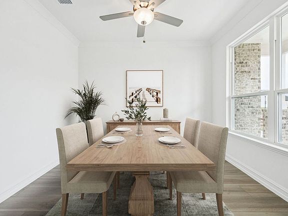 Elegant dining room in the Azle floorplan with easy access to the kitchen.