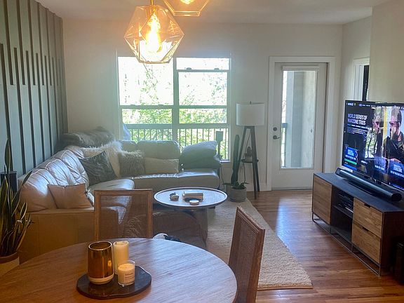 Living room space leading to patio that overlooks Jefferson Park