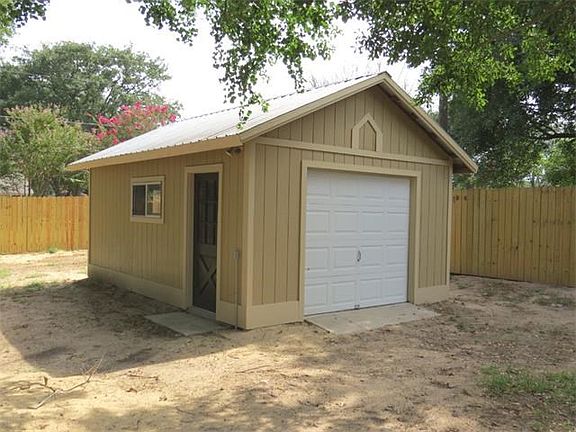 Storage building with garage door opener.