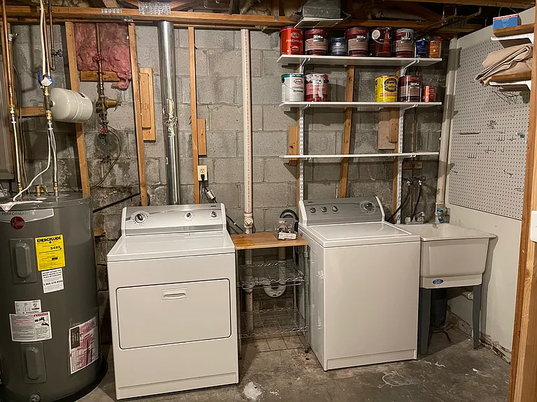 Laundry area of unfinished room in basement