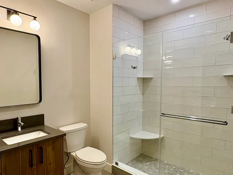 Bathrooms with Custom Title Showers and Vanity Lighting