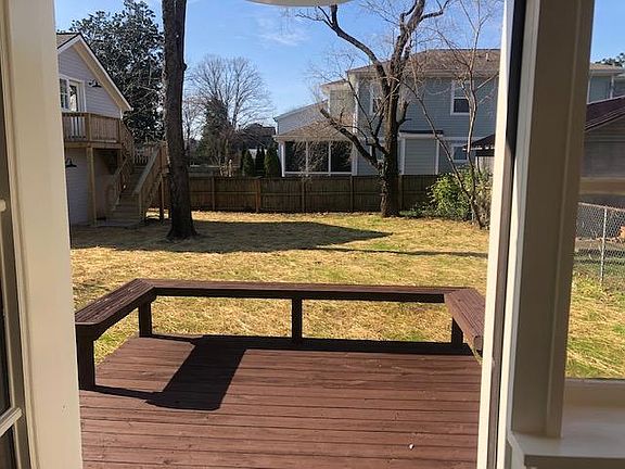 Back patio off kitchen/drop-area, looks out into large shaded back yard