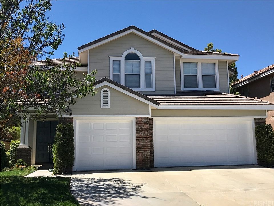 Front of the house with 3 car garage and double do