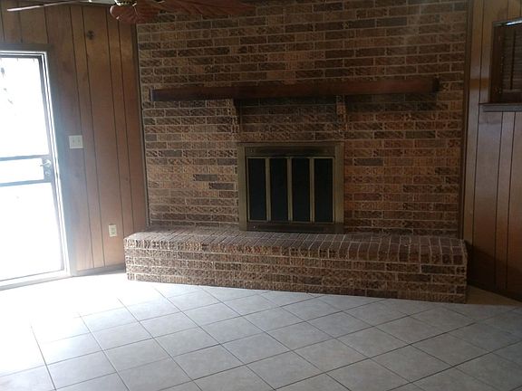Den with fireplace. Leading to back patio