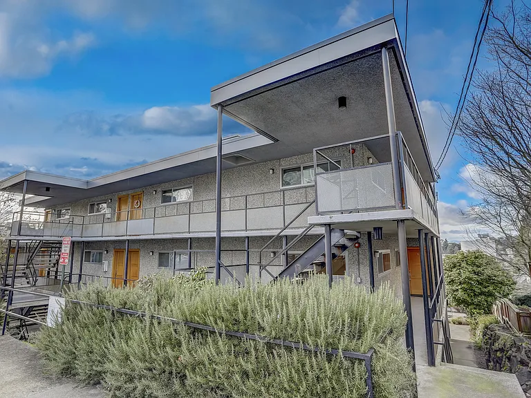 An exterior view of the building highlighting its architectural details and well-maintained landscaping, creating an inviting and aesthetically pleasing environment.