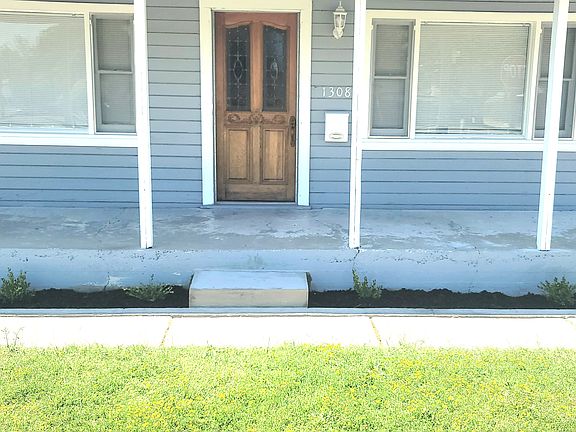 New front entry step and bushes.