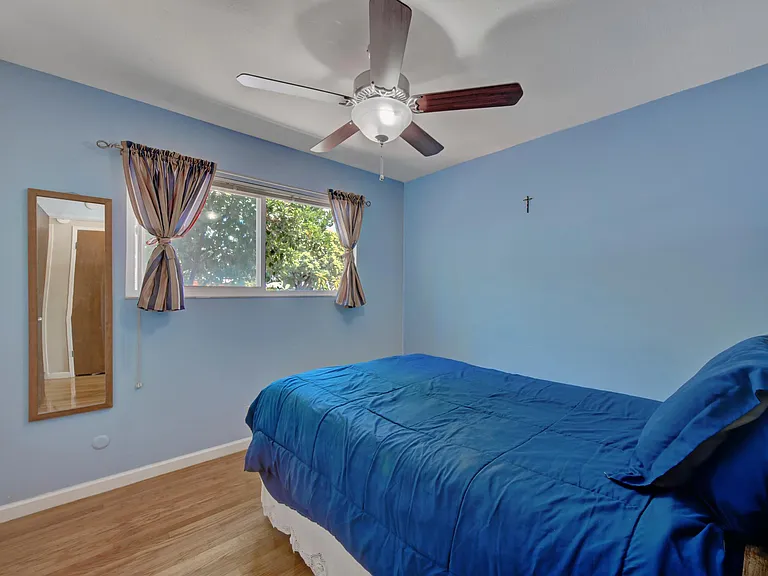 Third bedroom seen from the hallway. Window is on the north side of the house, view of fruit trees and cacti.