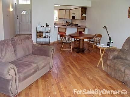 Livingroom open concept, vaulted ceiling, new paint and wood laminate floor