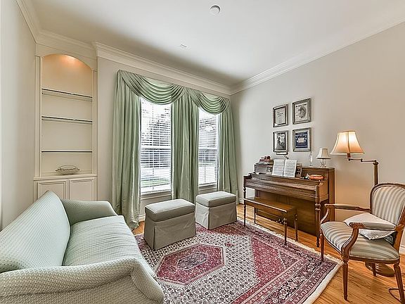 Another view of the Great Room highlighting the picturesque wall of windows overlooking the outdoor covered patio and expansive backyard.