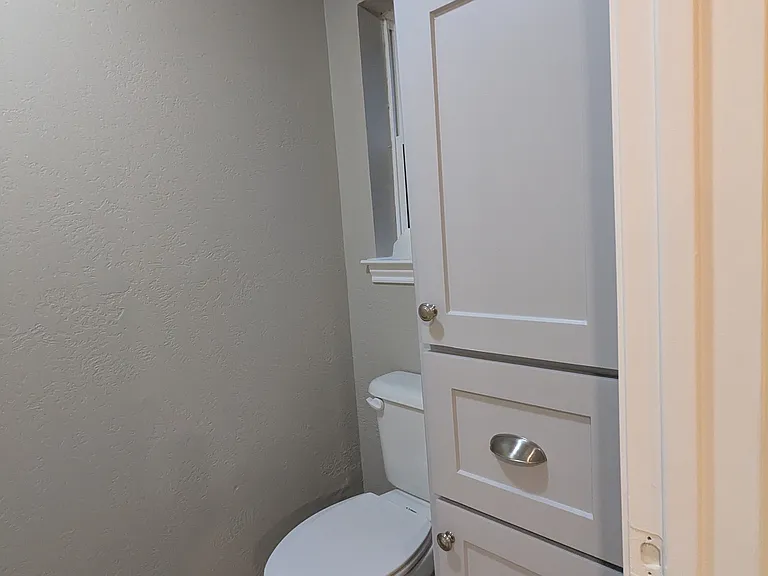 MASTER BATH SHOWER AND TOILET AREA: Notice the linen cabinet